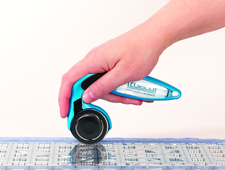 holding rotary cutter with finger